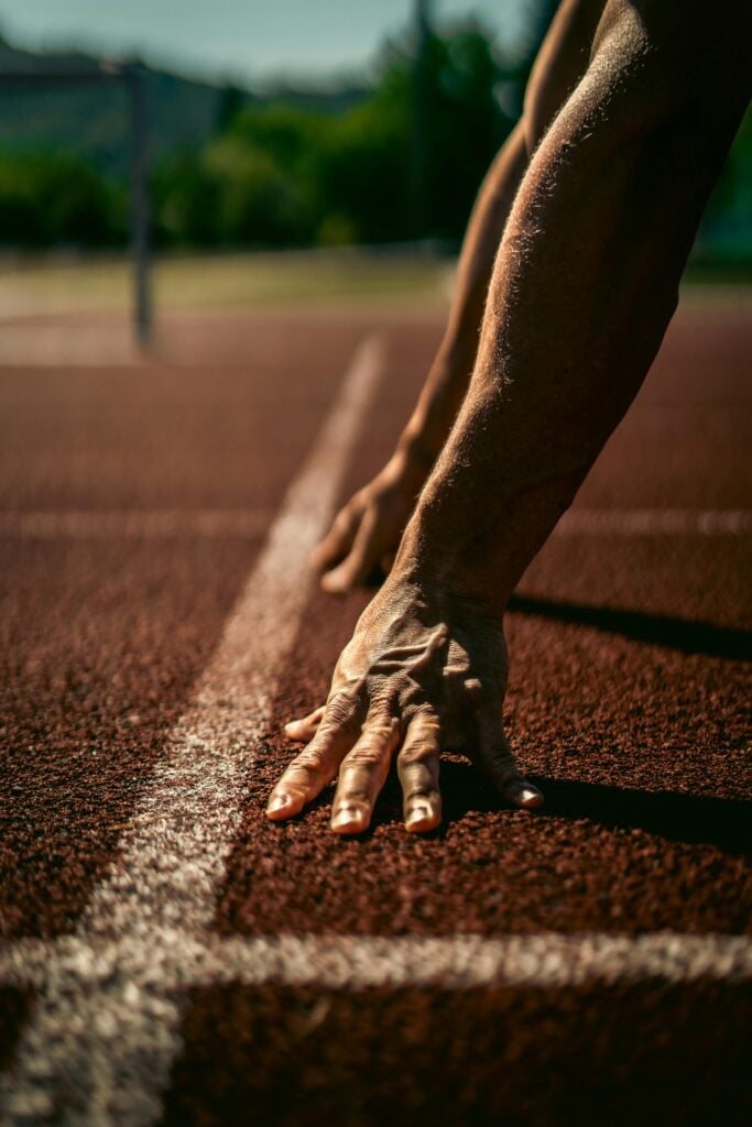 Man in athletic stance at a starting line, representing renewed drive and performance with TRT